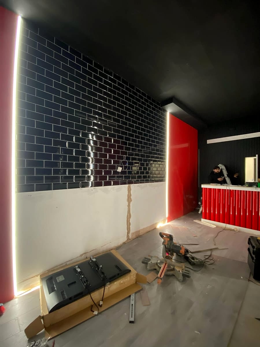 LED strip lighting the edges of the tiled feature wall at Cheat Daze