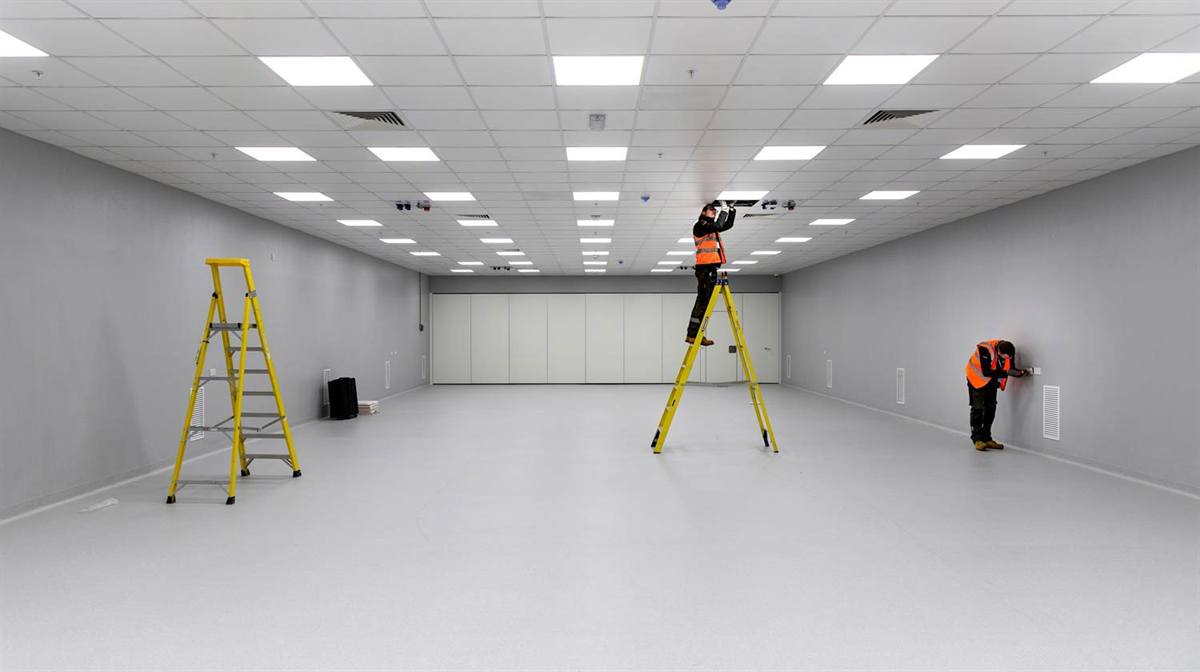 Wired & Certified electricians fitting LED panel lighting and sockets in a commercial unit