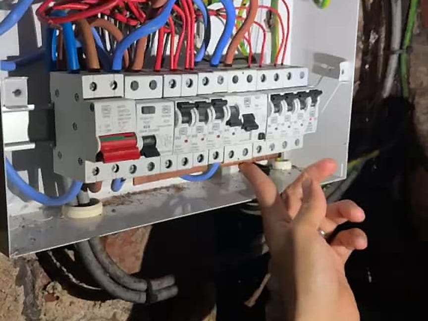 An electrician working on a consumer unit on an emergency callout