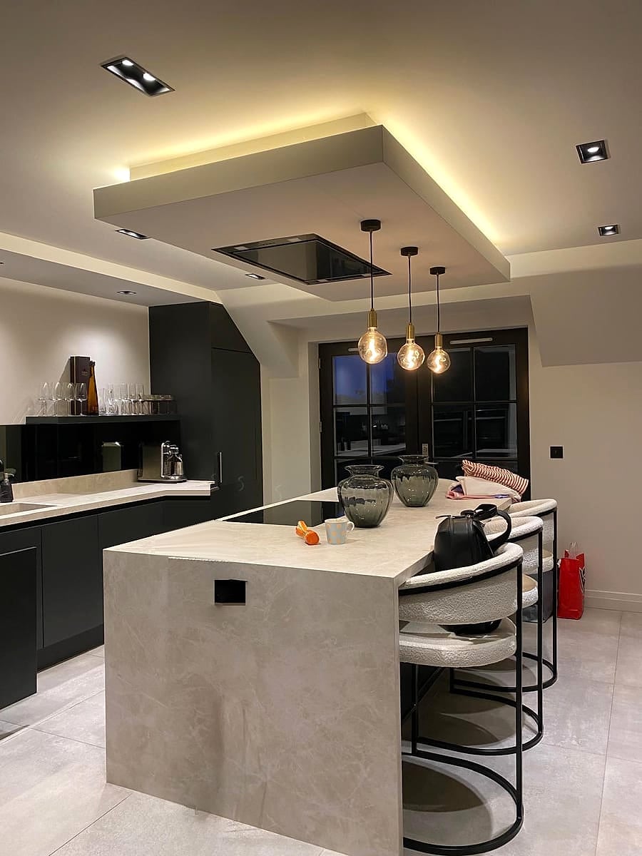 Kitchen island with pendant lights, an LED-lit ceiling raft and square downlights, fitted by Wired & Certified