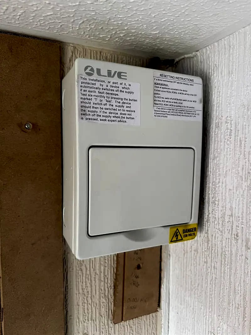 A new consumer unit fitted in the same spot as the old board, closed up and labelled